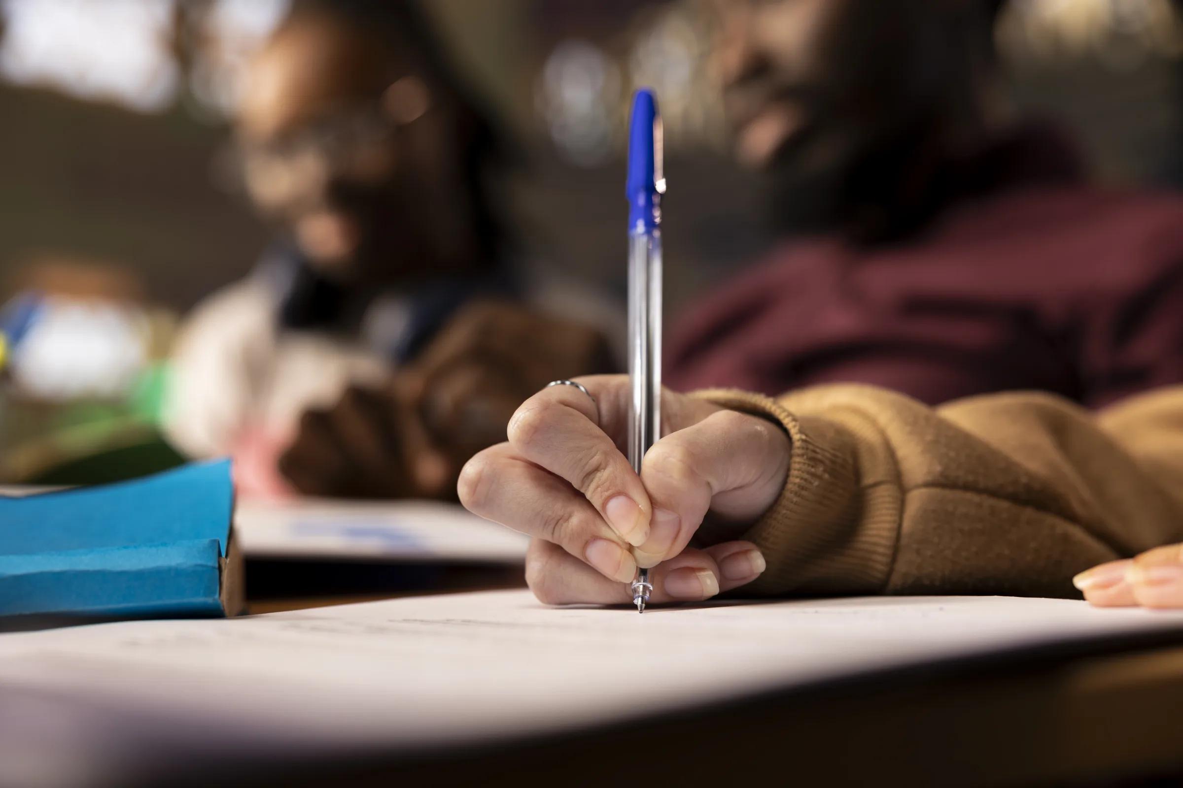A candidate writing the paper under exam conditions in a Banglay IELTS mock test